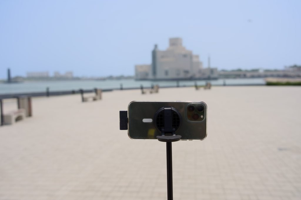 A photo of a K&F MS-19 stand being used for my iPhone so that I can film myself. With the Museum of Islamic Art in the background.