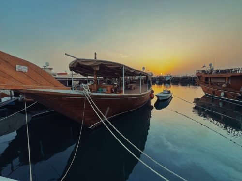 A photo of a Dhow Boat at Dhow Harbour at Sunset